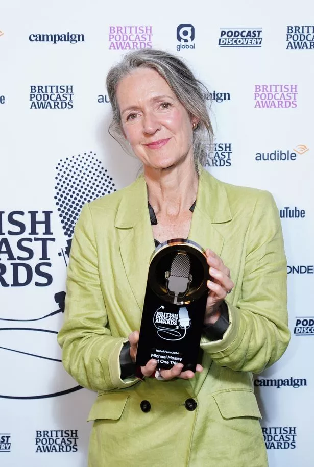 Dr Clare Bailey Mosley holding the Hall of Fame award at the British Podcast Awards 2024